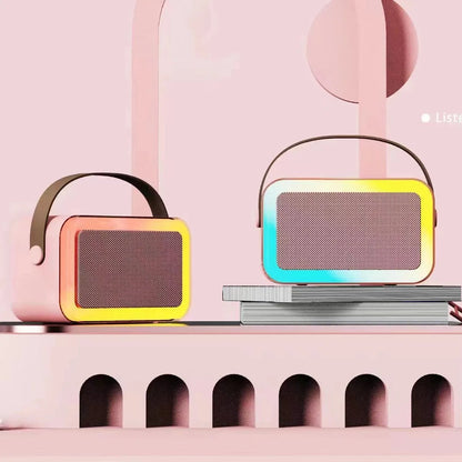 Portable Bluetooth karaoke microphone speaker with coloured LED lights in pink colour option showing microphone input and control buttons