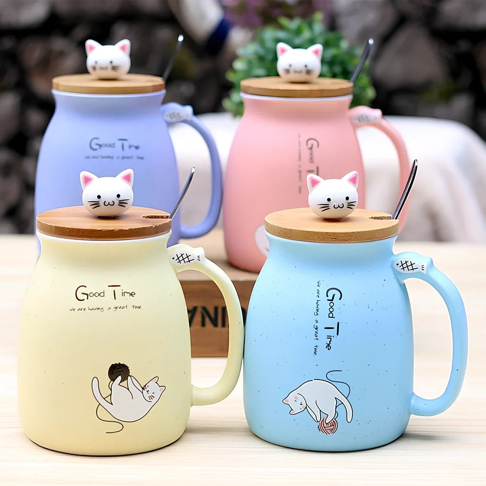 Pink ceramic mug with cartoon cat design, wooden lid, and stainless steel spoon on table