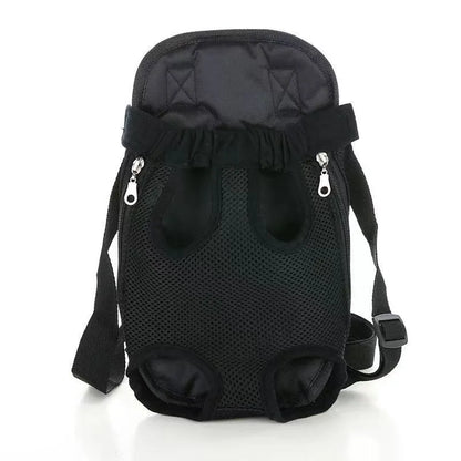 A small dog in a front-worn nylon carrier backpack with mesh panels, adjustable straps and side zips.