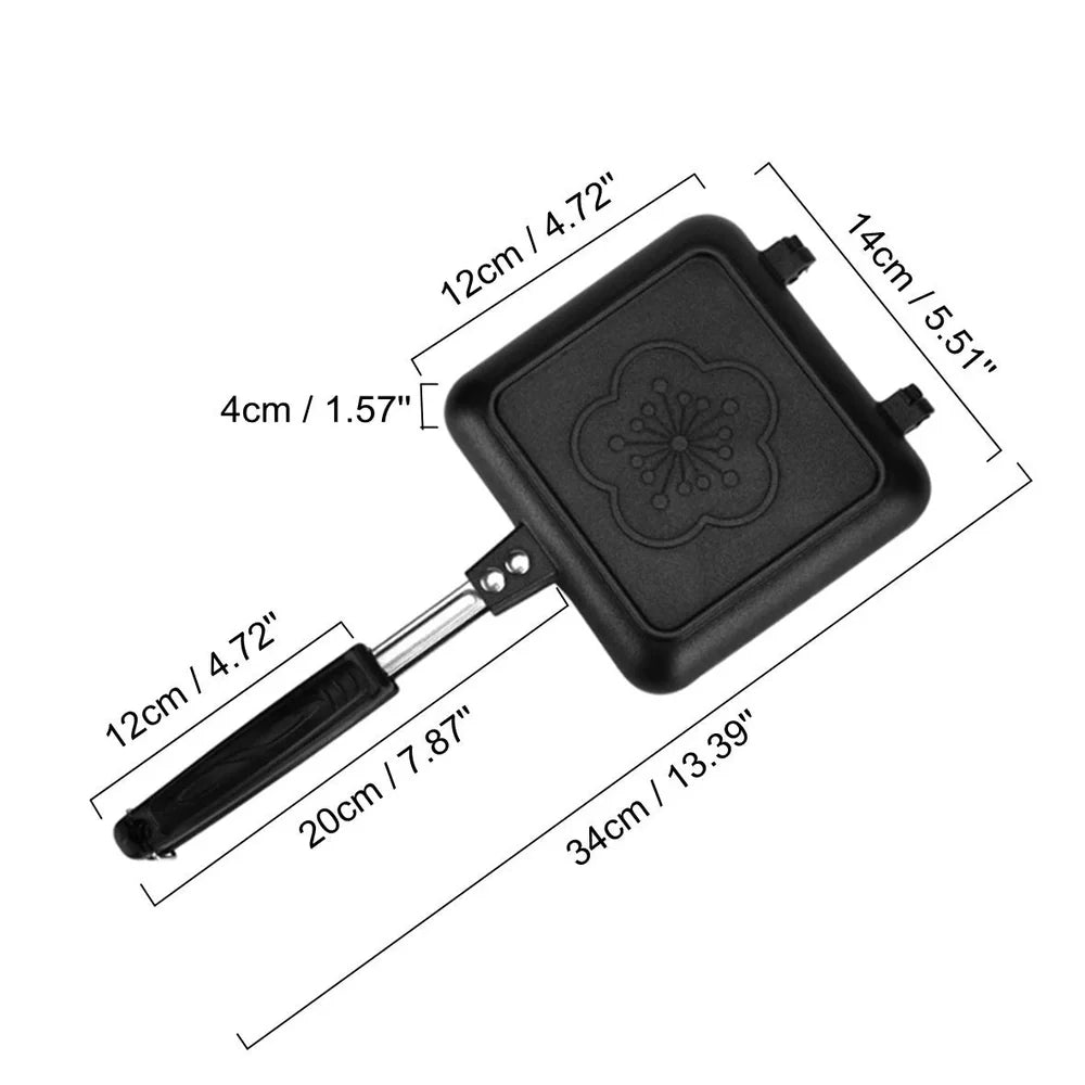 Black double-sided sandwich frying pan with heat-proof handle on stovetop