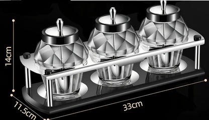 Glass seasoning jar with spoon cover for solid spices like salt and pepper on kitchen counter