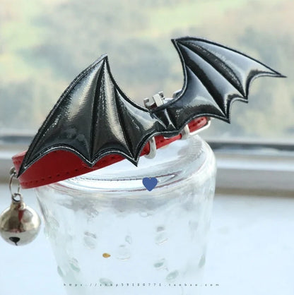 Black patent leather choker with 15cm wings decoration and bell attachment on adjustable 30-40cm collar