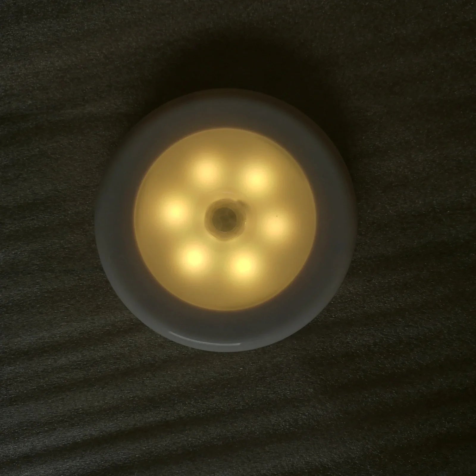 White motion-sensing LED cabinet lamp with magnetic back for wireless installation