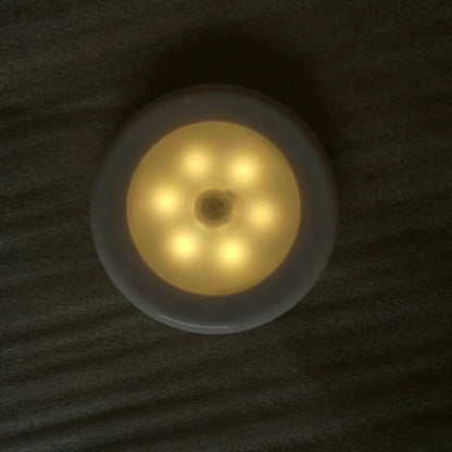 White motion-sensing LED cabinet lamp with magnetic back for wireless installation
