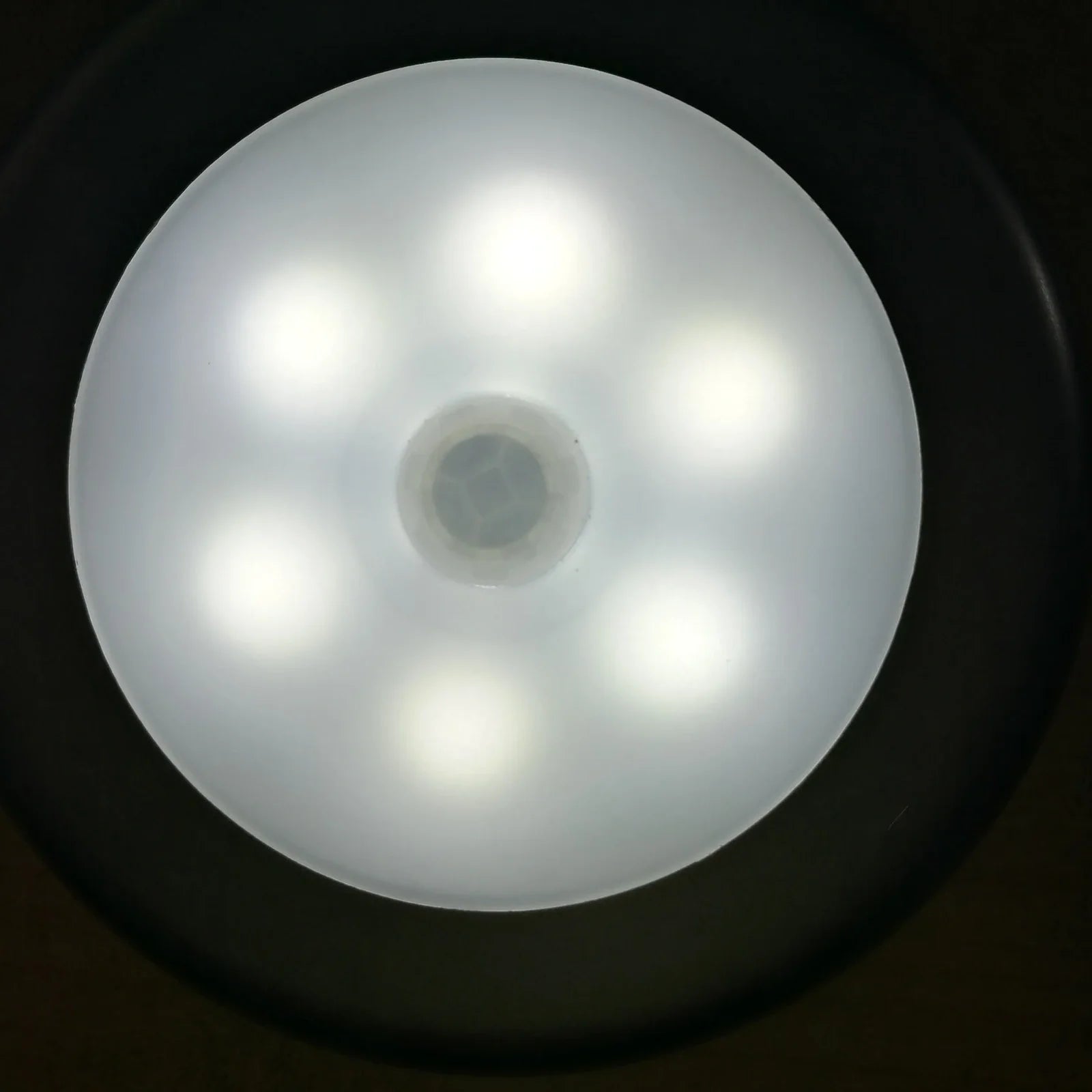 White motion-sensing LED cabinet lamp with magnetic back for wireless installation