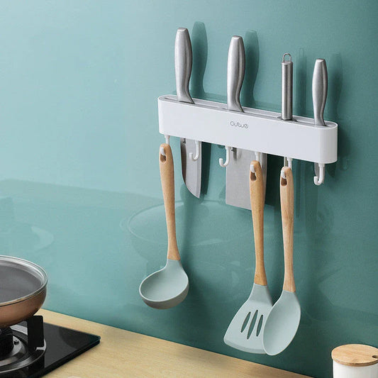 Sleek wall-mounted knife organizer with slots for knives and hooks for storing kitchen essentials
