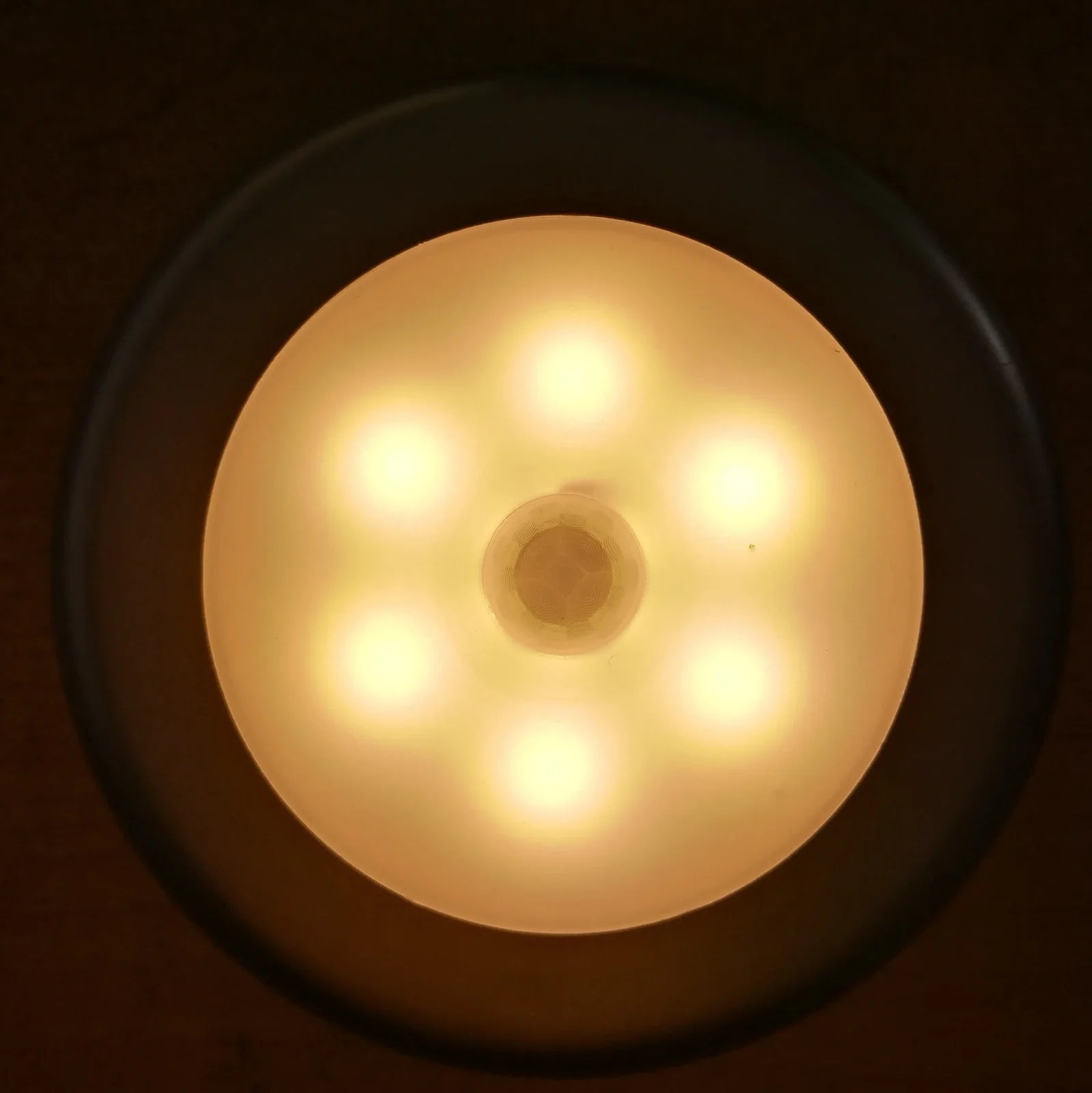 White motion-sensing LED cabinet lamp with magnetic back for wireless installation