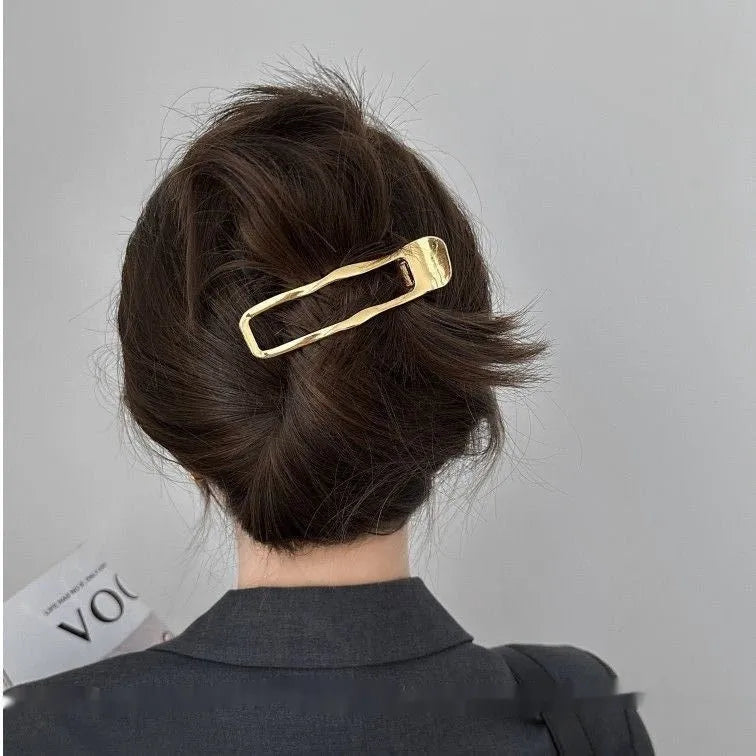 Women's gold and silver zinc alloy hair barrettes in arc, square, and triangle shapes.