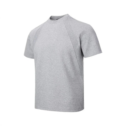 Man's loose fit black short sleeve top with textured air layer stitching detail.