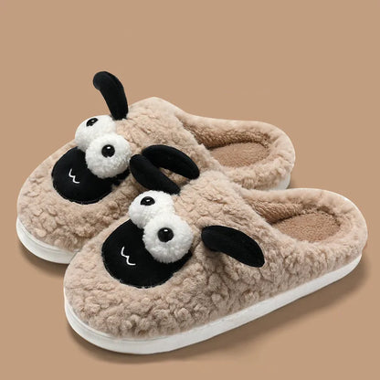 Brown suede slip-on slippers with thermal cotton body and sewn PVC sole on a wooden floor.