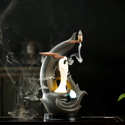 Purple sand tea pet backflow fragrance ornament with LED lighting creating cascading smoke effect