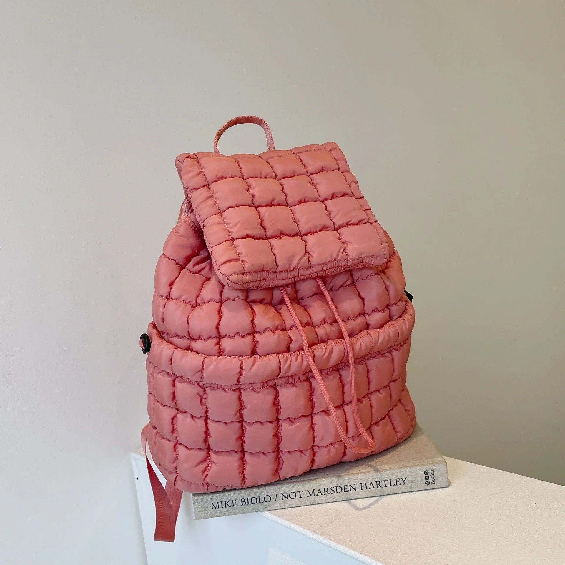 Soft, quilted puffer backpack in a variety of colors, perfect for autumn and winter wear