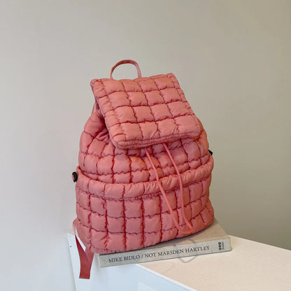 Soft, quilted puffer backpack in a variety of colors, perfect for autumn and winter wear