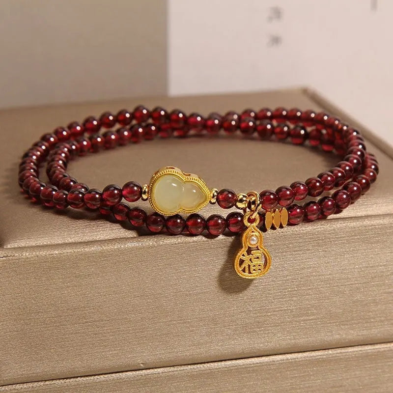 Handmade antique Chinese style bracelet with red imitation garnet and pomegranate design in a gift box.