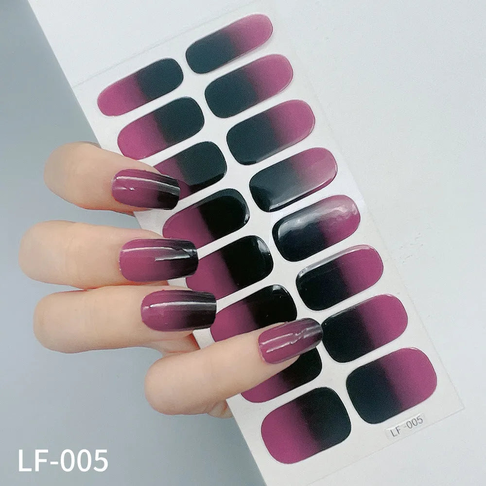 Sheet of 16 small design nail art stickers including cross, rose, tulip and marble patterns.