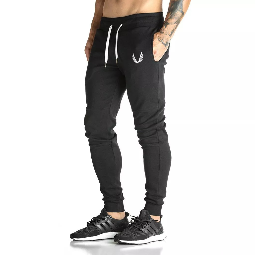 Running training pants in black, light gray, or dark gray with 95% cotton fabric and cord closure
