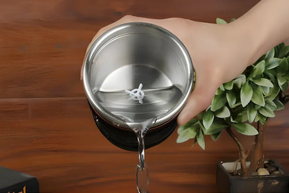 Self-stirring camera lens mug with stainless steel construction and automatic mixing button