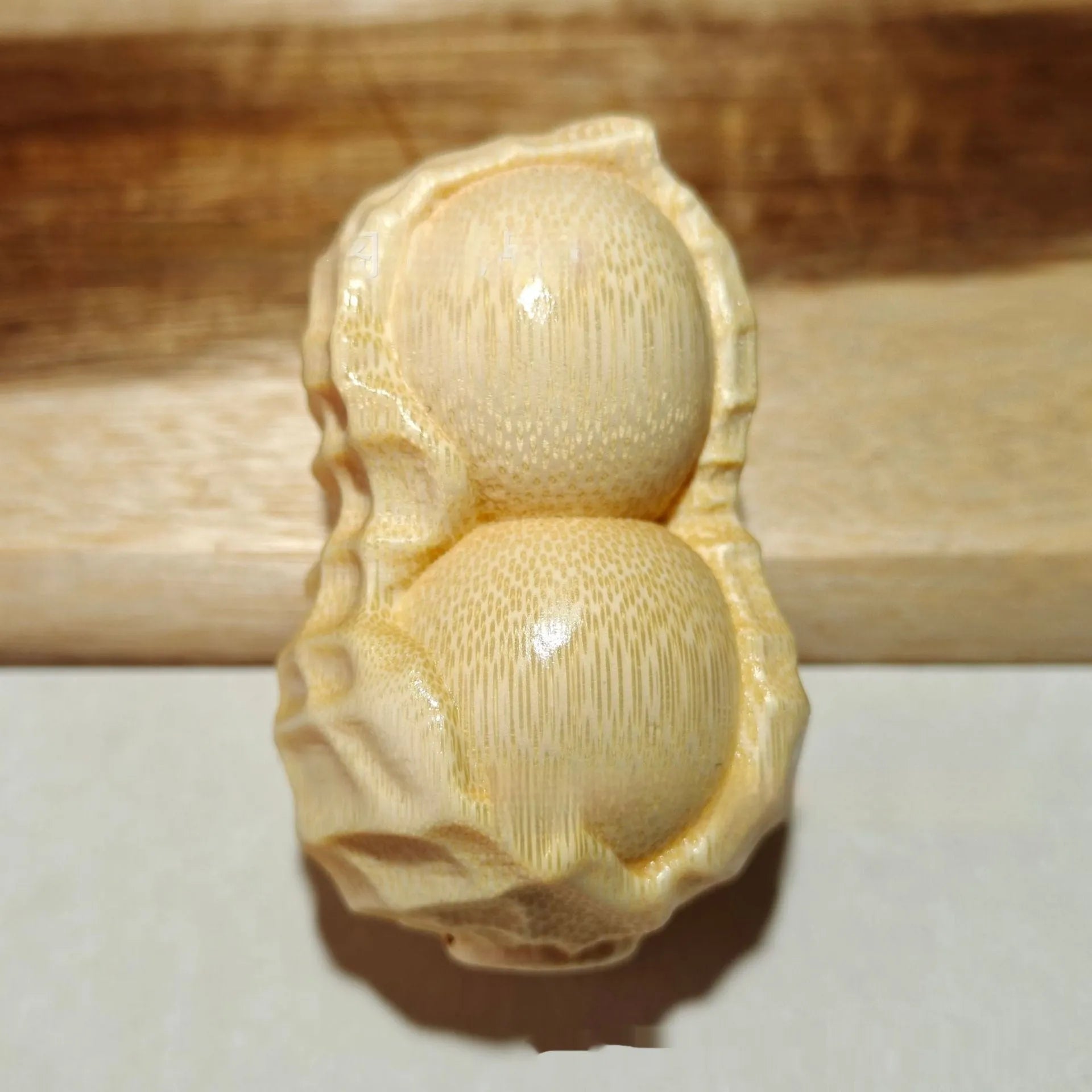 Hand-carved solid bamboo peanut ornament with modern design for gifting and decor
