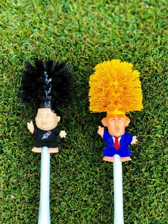 Comical Donald Trump-themed toilet brush made of durable plastic with a bold yellow color and convenient hanging slot