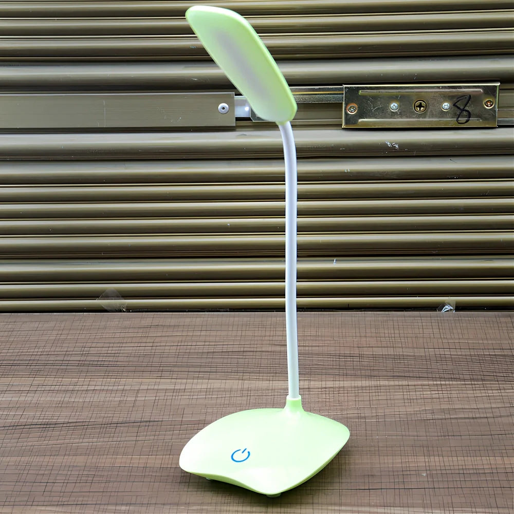 White foldable LED desk lamp with touch button and USB charging port on a desk