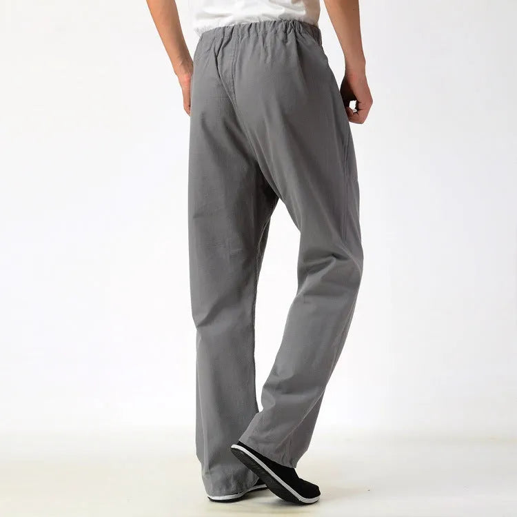 Men's beige pure cotton casual trousers with a drawstring waist on a mid-grey background.
