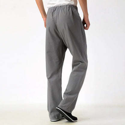 Men's beige pure cotton casual trousers with a drawstring waist on a mid-grey background.