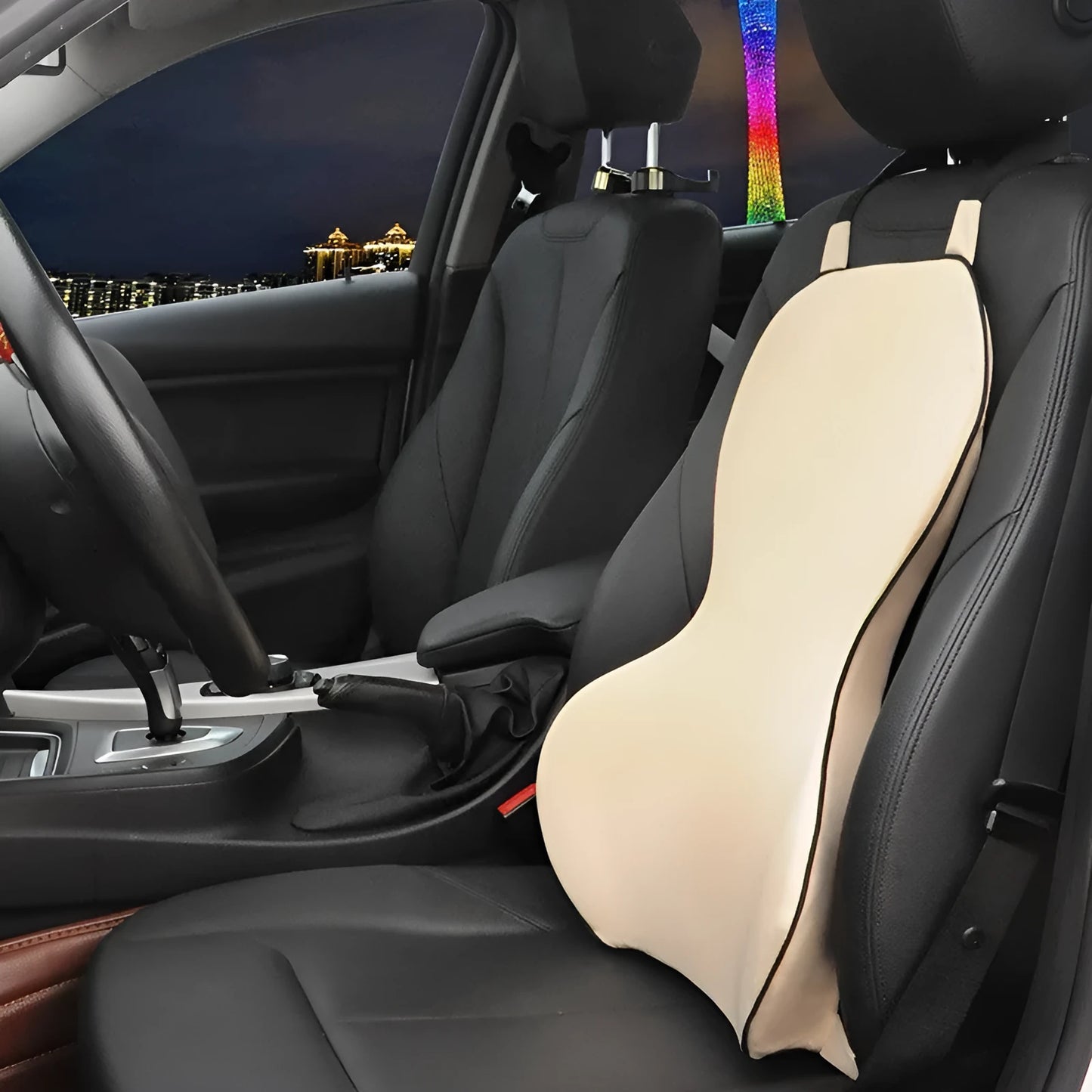 Memory cotton car lumbar support cushion in grey, showing its contoured shape on a car seat.