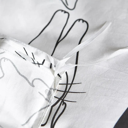 White cotton bedding set with active printed pattern, showing duvet cover, fitted sheet and pillowcases