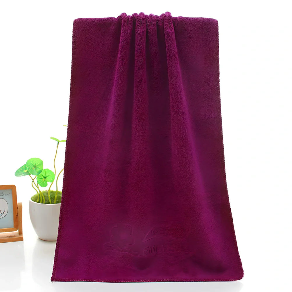 Blue microfiber towel with embossed texture measuring 70cm by 140cm with finished edges