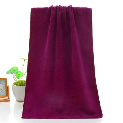 Blue microfiber towel with embossed texture measuring 70cm by 140cm with finished edges