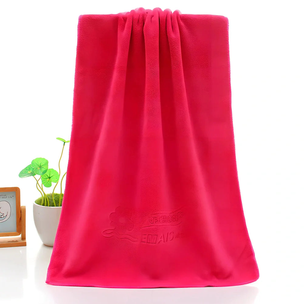 Blue microfiber towel with embossed texture measuring 70cm by 140cm with finished edges