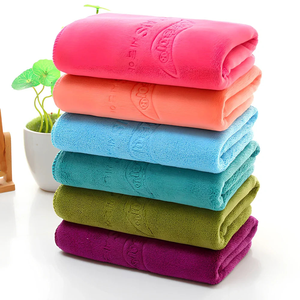 Blue microfiber towel with embossed texture measuring 70cm by 140cm with finished edges