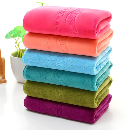 Blue microfiber towel with embossed texture measuring 70cm by 140cm with finished edges