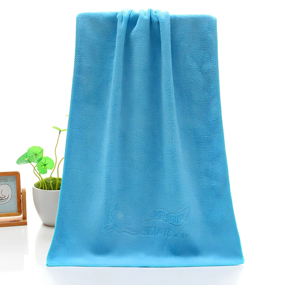 Blue microfiber towel with embossed texture measuring 70cm by 140cm with finished edges