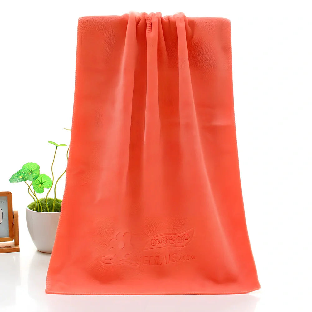 Blue microfiber towel with embossed texture measuring 70cm by 140cm with finished edges