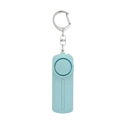 Compact pink self-defense alarm showing 86mm length with activation button and LED light