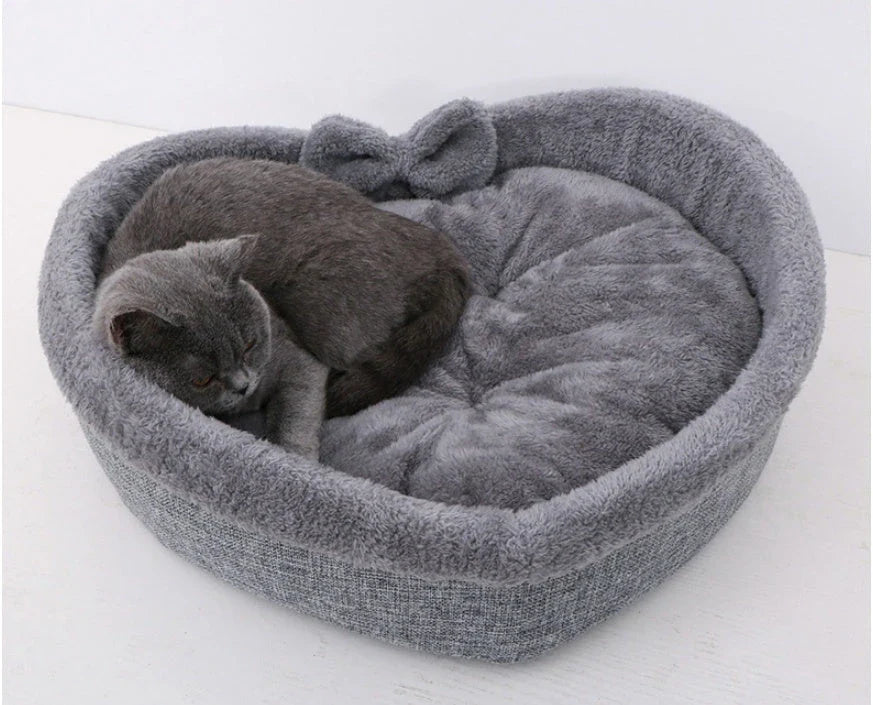 Cozy heart-shaped pet bed in grey and pink colors, suitable for cats and small dogs