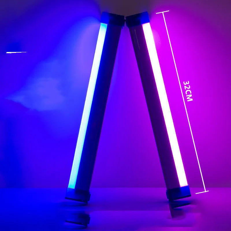 Blue rechargeable LED light tube with USB plug and push-button switch on a dark surface