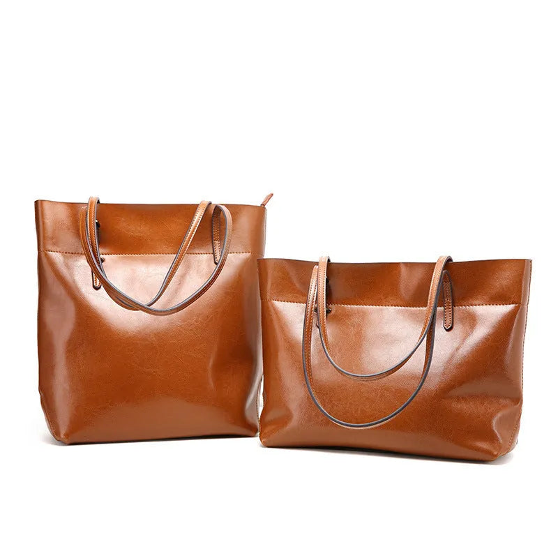 Leather cross-body handbag in Black colour with dimensions 30cm by 37cm by 13cm, showing internal pockets