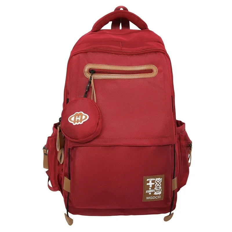 Large nylon school backpack for middle school students in a solid colour with curved shoulder straps.