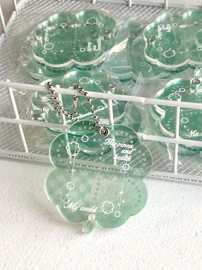 Blue, green, and mint green four-leaf clover acrylic pendant keychain on a metal ring.