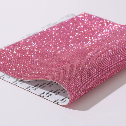 Rhinestone sticker net on backing sheet for hot drilling application to fabrics in multiple colour options