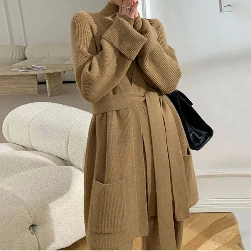 Women's knitted three-piece set with wide-leg trousers, cardigan, and top in solid colours, showing leather stitching details