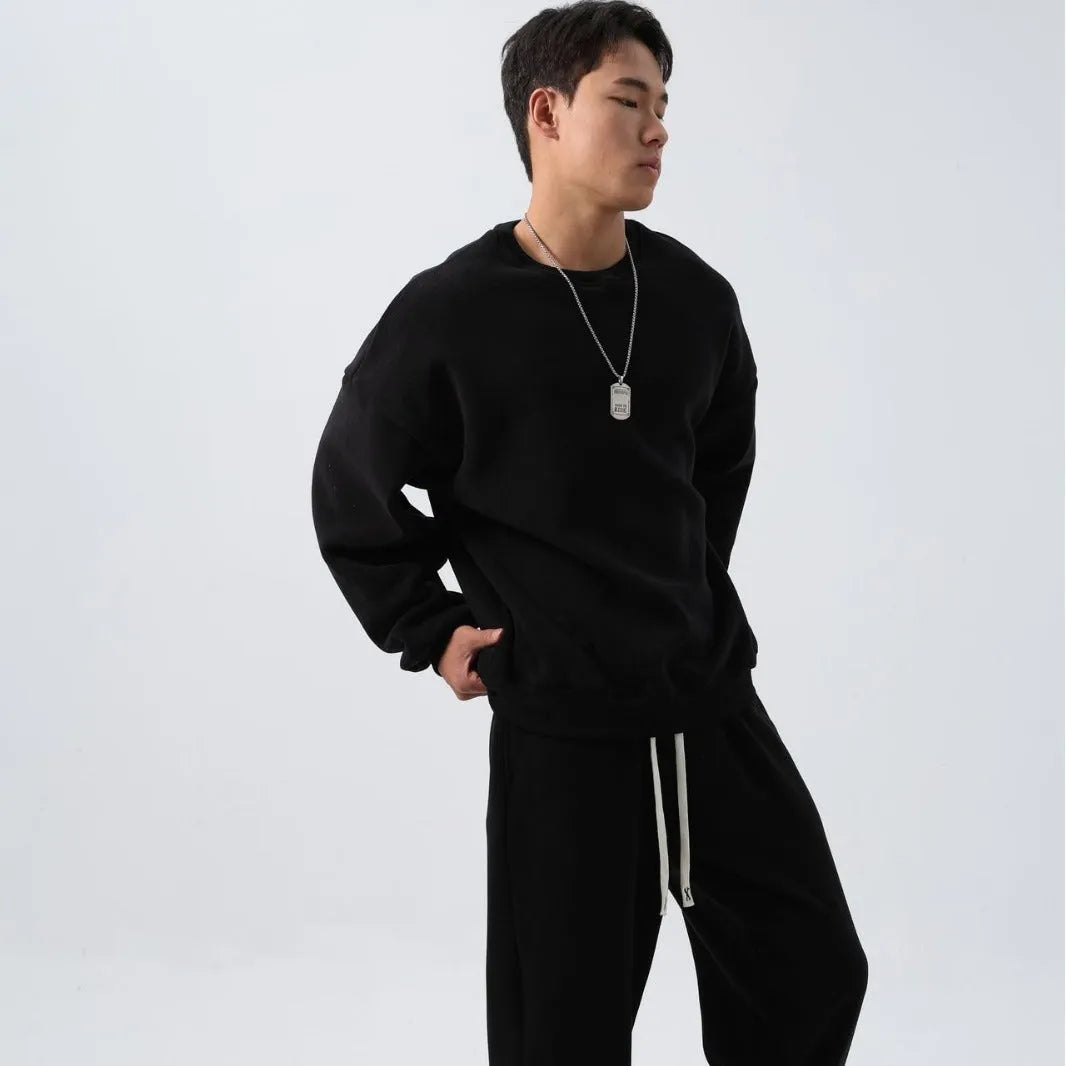 Man wearing a two-piece army green polar fleece suit with crew neck top and padded trousers.