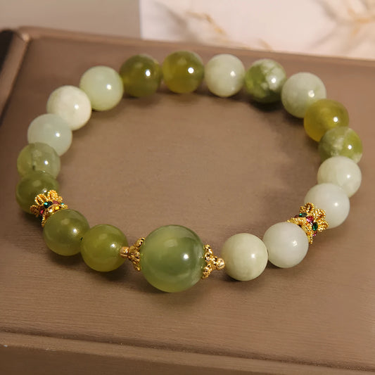 Original design women's bracelet with a green Xiuyan jade stone on wrist.