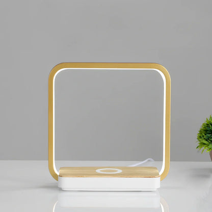 Modern bedside lamp with wireless charging pad and adjustable LED lighting in gold finish