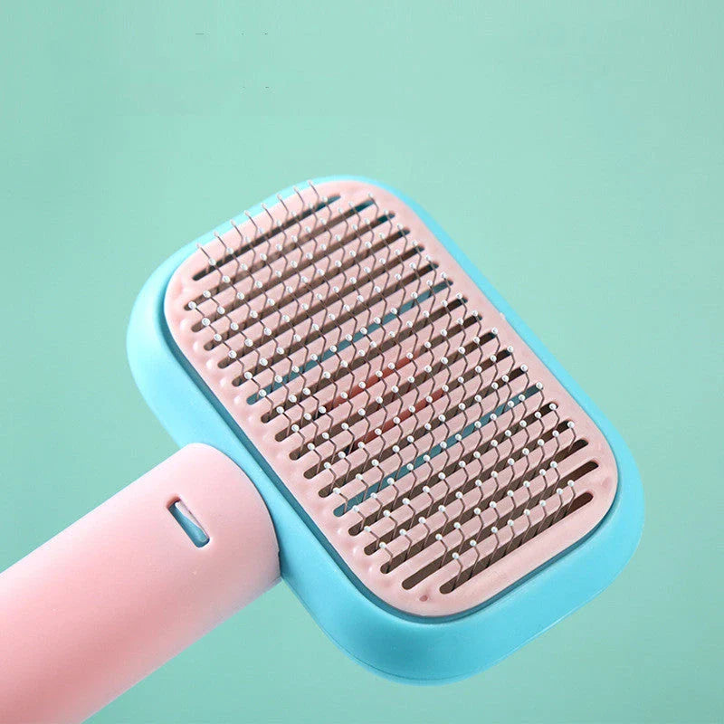 Premium pet hair brush in grey, pink, and green colors with stainless steel construction for easy grooming and massage