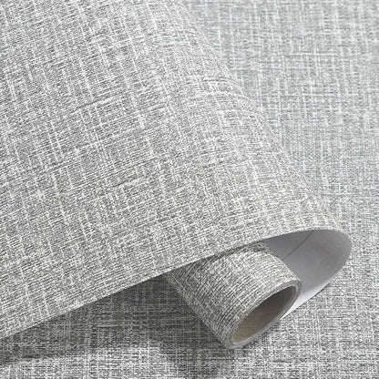 Roll of textured linen self-adhesive wallpaper in a beige colour, showing peel-off backing and double-layer construction.