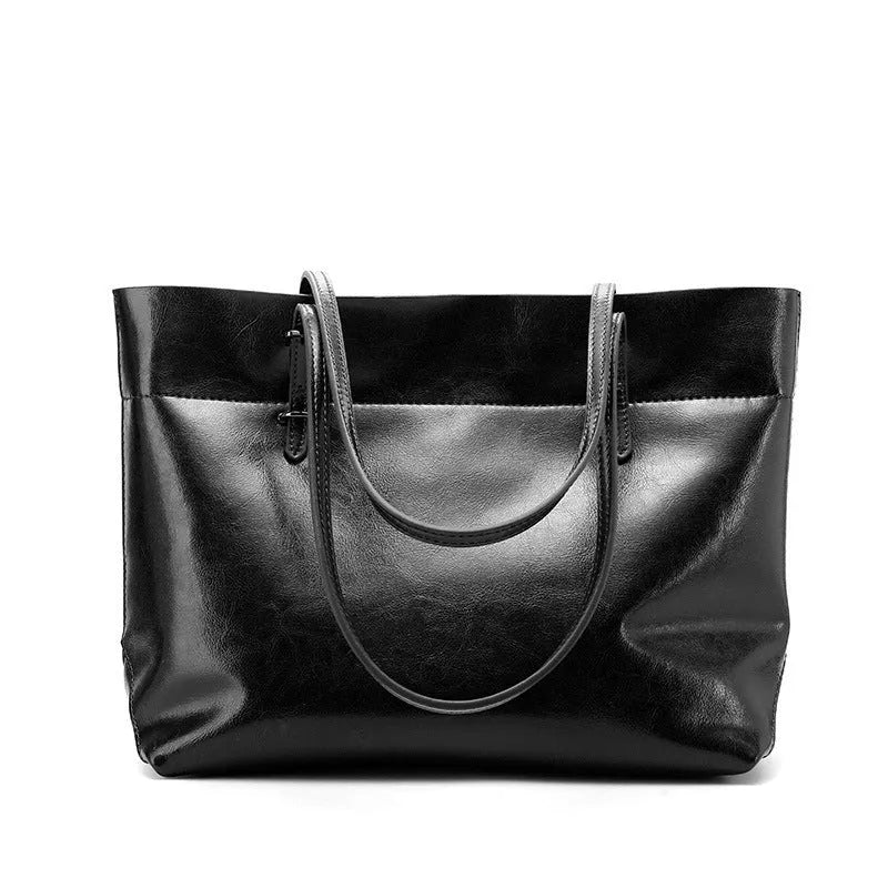 Leather cross-body handbag in Black colour with dimensions 30cm by 37cm by 13cm, showing internal pockets