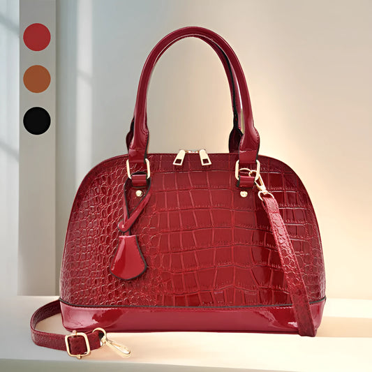 Shiny black PU leather crossbody bag with a structured shell shape and a long strap.